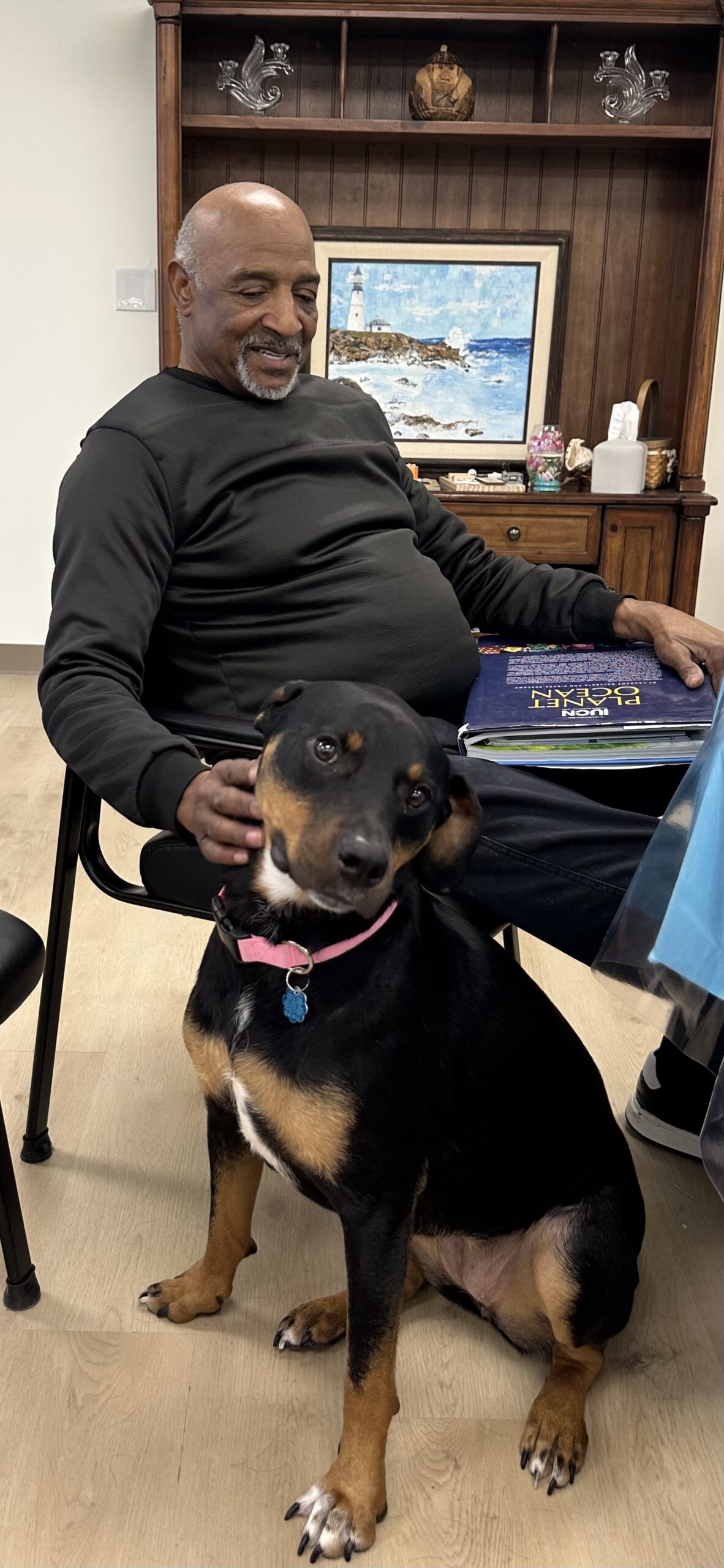 A participant petting a visiting comfort dog
