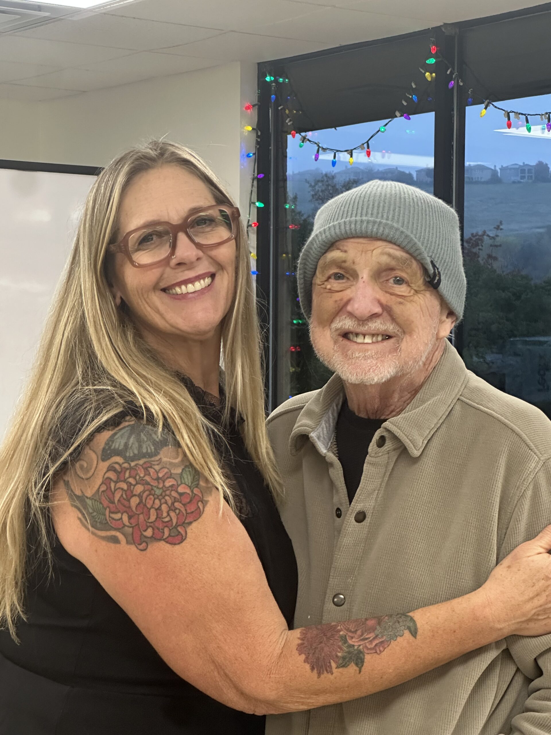 A Daycation staff member hugging a smiling participant